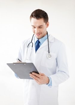 bright picture of male doctor writing prescription