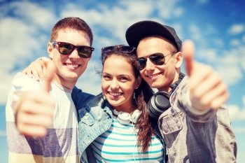 summer holidays and teenage concept - group of smiling teenagers showing thumbs up