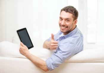 technology, home and lifestyle concept - smiling man working with tablet pc computer at home showing thumbs up