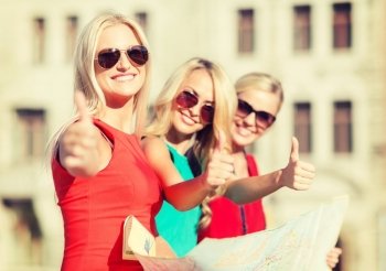 holidays and tourism concept - beautiful blonde women with tourist map showing thumbs up in the city
