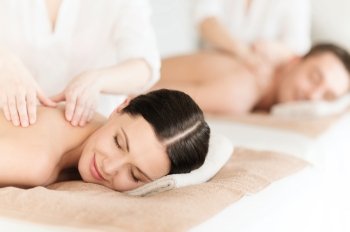 health and beauty, resort and relaxation concept - couple in spa salon getting massage