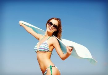 summer holidays, vacation and beach concept - girl in bikini and shades on the beach