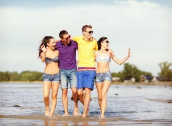 summer, holidays, vacation, happy people concept - group of friends having fun on the beach