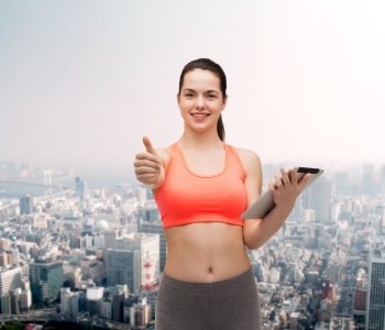 sport, exercise, technology, internet and healthcare - sporty woman with tablet pc computer showing thumbs up