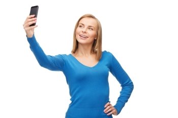 technology and internet concept - smiling woman taking self picture with smartphone camera