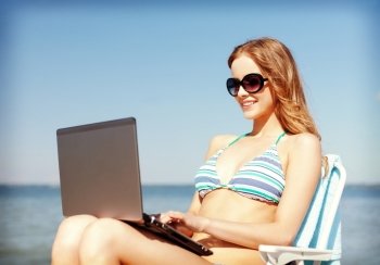 summer holidays, vacation, technology and internet - girl looking at tablet pc on the beach chair