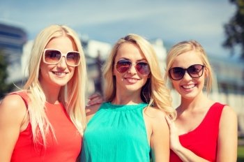 holidays and tourism, friends, hen party, blonde girls concept - three beautiful women in the city