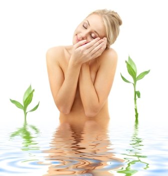 picture of blonde with flower petals and green plants in spa