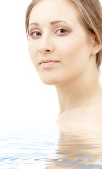 beautiful woman with moisturizing milk drops on face in water