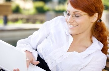 portrait of smiling businesswoman with laptop computer