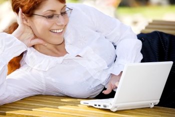 businesswoman with laptop computer in the park