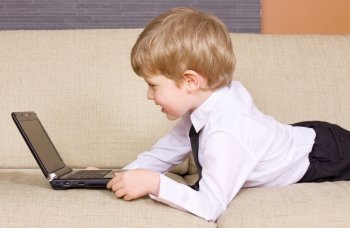 picture of happy boy with black laptop computer