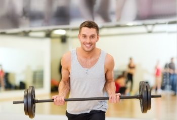 fitness, sport, training, gym and lifestyle concept - smiling man with barbell in gym