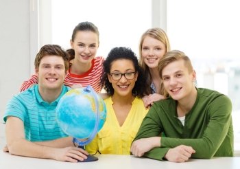 education, travel and geography concept - five smiling student with earth globe at school