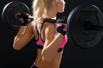 fitness, sport and dieting concept - sporty woman exercising with barbell from back