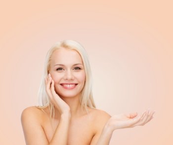 health, cosmetics, advertising and beauty concept - smiling woman holding imaginary lotion jar and applying it