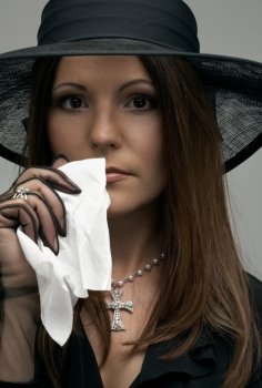 crying christian lady in black funeral dress