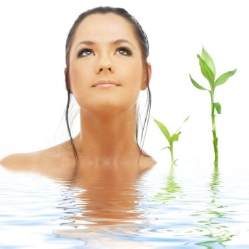picture of lovely brunette with bamboo in water