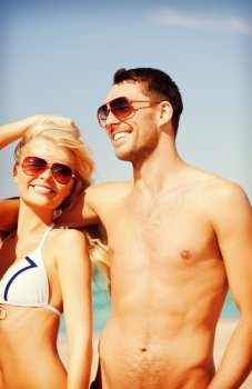 picture of happy couple in sunglasses on the beach