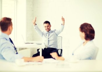 picture of happy businessman showing thumbs up in office