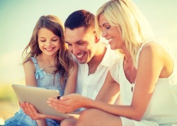 summer holidays, children and people concept - happy family with tablet pc taking picture