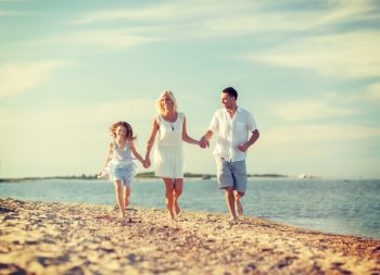 summer holidays, children and people concept - happy family at the seaside