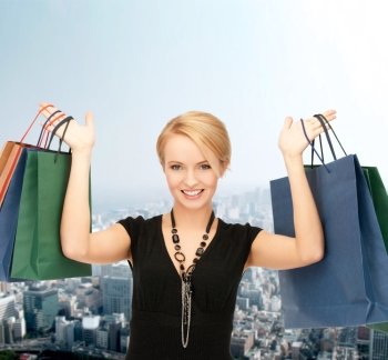 shopping and retail concept - lovely woman with shopping bags