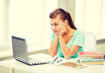 picture of stressed student with computer at home