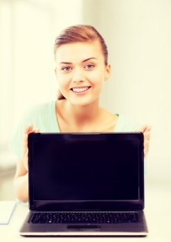 education, technology and internet concept - smiling student girl with laptop