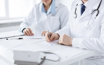 picture of doctor and nurse writing prescription paper
