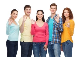 friendship, youth and people concept - group of smiling teenagers showing ok sign
