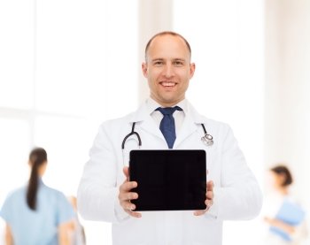 medicine, advertisement and teamwork concept - smiling male doctor with stethoscope showing tablet pc computer screen over group of medics