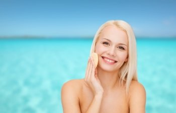 health, beauty and spa concept - beautiful woman with sponge