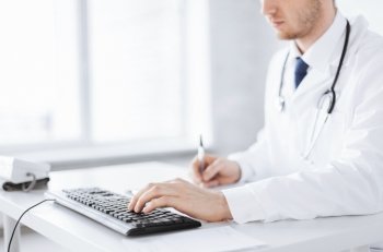 close up of male doctor typing  on the keyboard