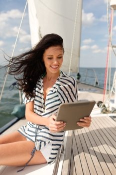 vacation, holidays travel, sea and technology concept - smiling woman sitting on yacht with tablet pc