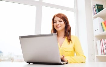 business, office, school and education concept - smiling businesswoman with laptop computer in office