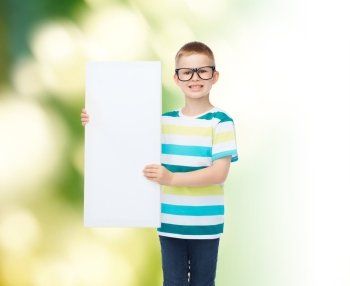vision, health, advertisement, ecology and people concept - smiling little boy wearing eyeglasses with white blank board over green background