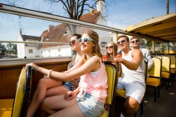 friendship, travel, vacation, summer and people concept - group of smiling friends traveling by tour bus