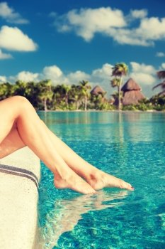summer, beach, leisure and body part concept - closeup of woman legs at swimming pool