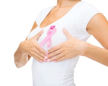 healthcare and medicine concept - woman in blank t-shirt with pink breast cancer awareness ribbon checking breast