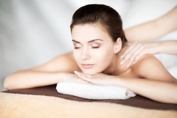 beauty and spa concept - woman in spa salon getting massage