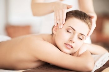 beauty and spa concept - beautiful woman in spa salon getting massage