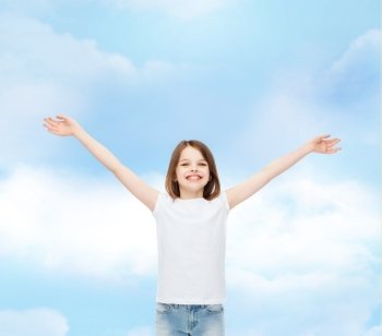 advertising, dream, childhood, gesture and people - smiling little girl in white t-shirt with stretched out arms over cloudy sky background