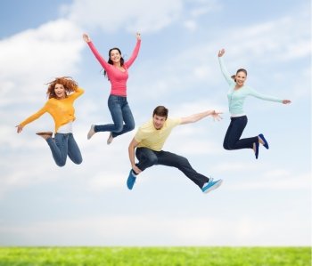 happiness, freedom, friendship, movement, summer and people concept - group of smiling teenagers in air over natural background