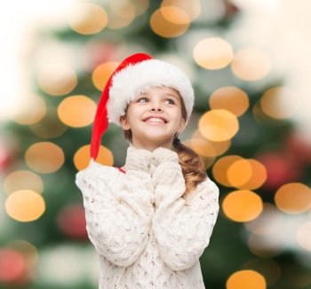 christmas, xmas, winter and happiness concept - dreaming girl in santa helper hat