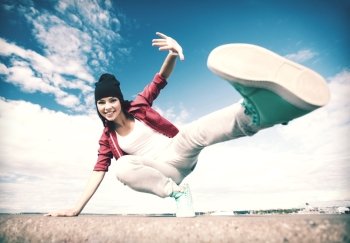 sport, dancing and urban culture concept - beautiful dancing girl in movement