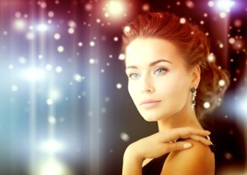 jewelry, luxury, vip, nightlife, party concept - beautiful woman in evening dress wearing diamond earrings