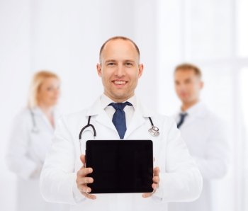 medicine, advertisement and teamwork concept - smiling male doctor with stethoscope showing tablet pc computer screen over group of medics