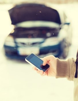 transportation, winter and vehicle concept - closeup of man with broken car and cell phone