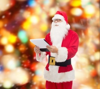 christmas, holidays and people concept - man in costume of santa claus with notepad over red lights background